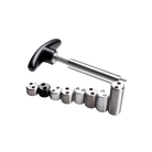 Metal Weight Bolts Ranging In Size Next To Metal Installation Tool With Black Handle