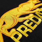 Close-up of gold embroidered Predator details