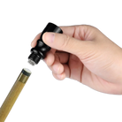 Hand Using a Black Cue Tip Tapper on a Cue Tip