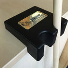 BCN Single-Slot Table-Edge Cue Holder In Black With A Gold BCN Badge, Clamped To A Table Edge And Holding A Cue